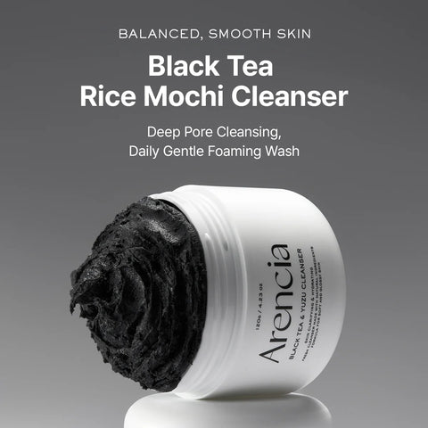 Arencia Black Tea Rice Mochi Cleanser with black scrub on a gray background