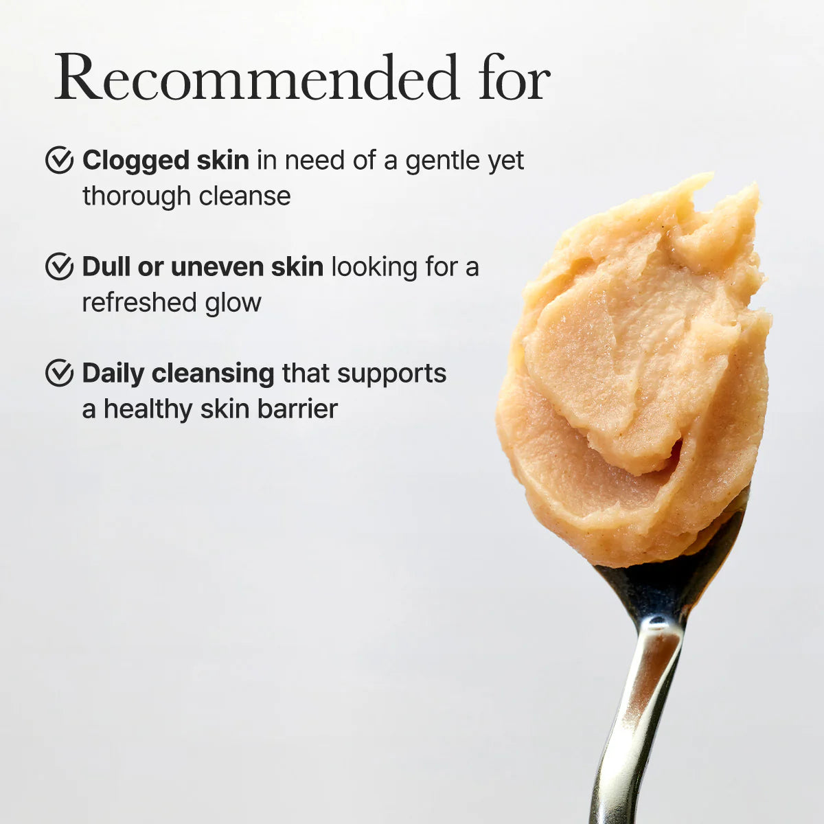 Spoon with beige cream and text about skin care recommendations on a light gray background