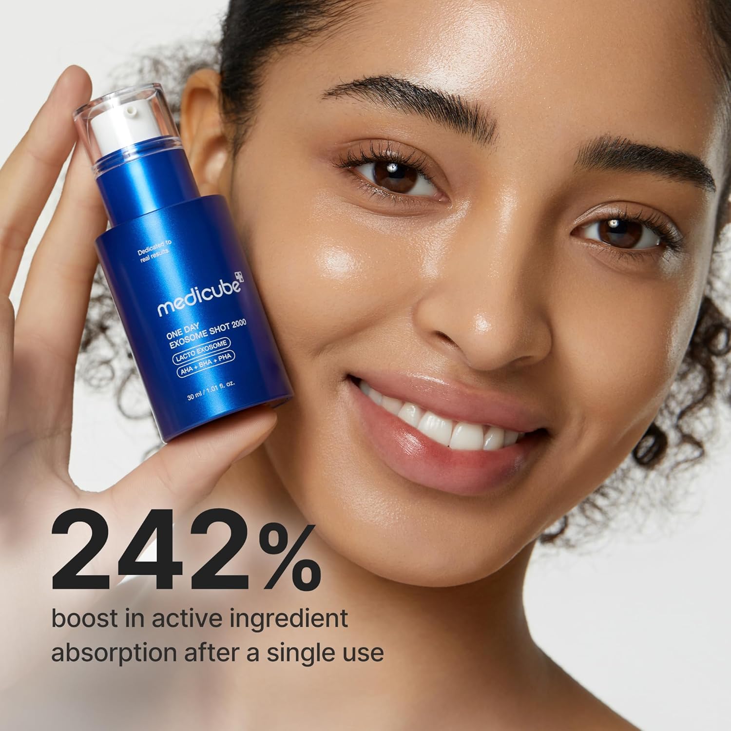 Woman holding a blue skincare product with text about active ingredient absorption by nouraskincare