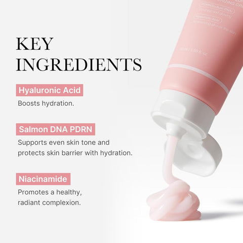 Cosmetic tube with pink cream being squeezed, featuring key ingredients on a white background.